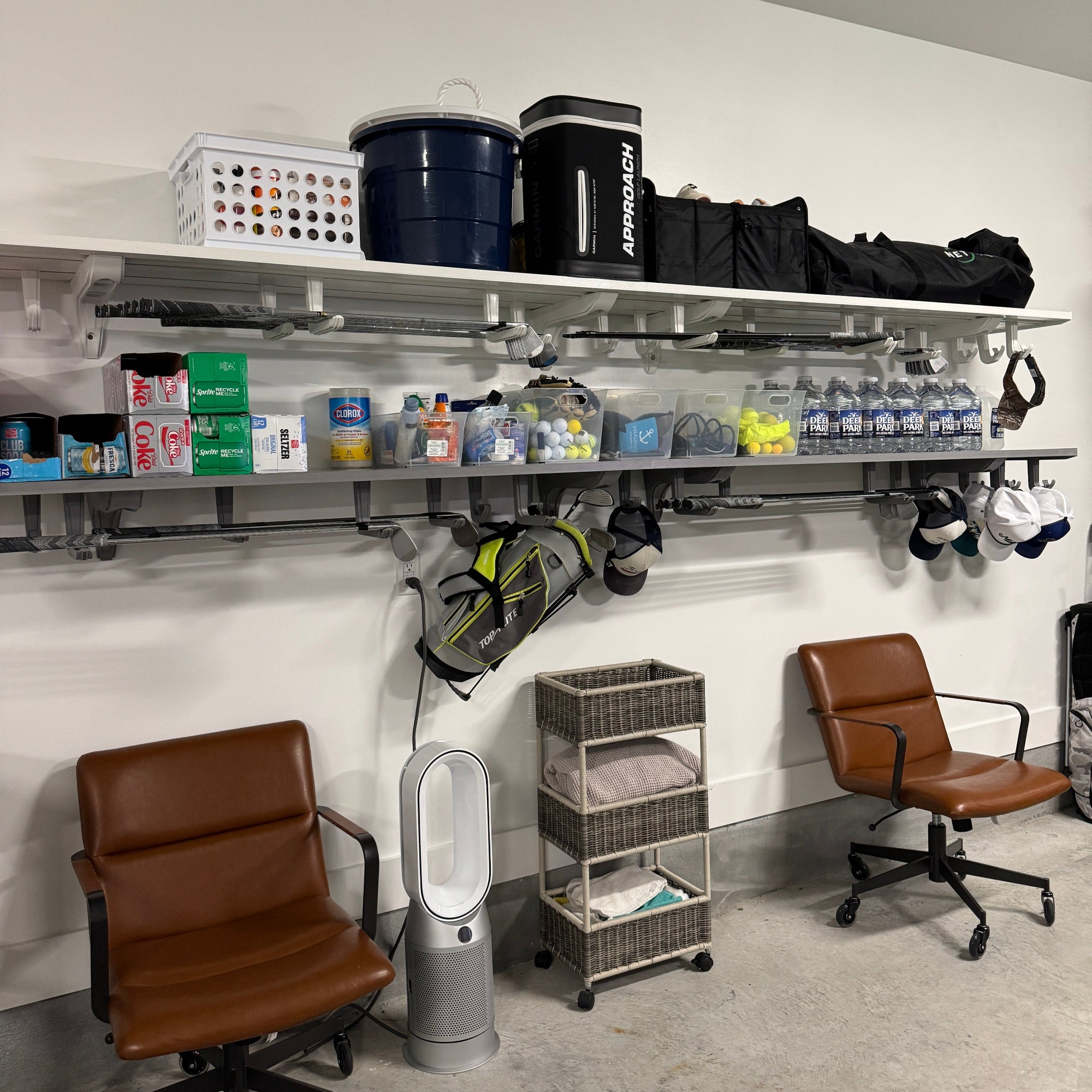 all-groups Garage storage system with shelves, chairs, and various items like golf bags and clubs, and hats