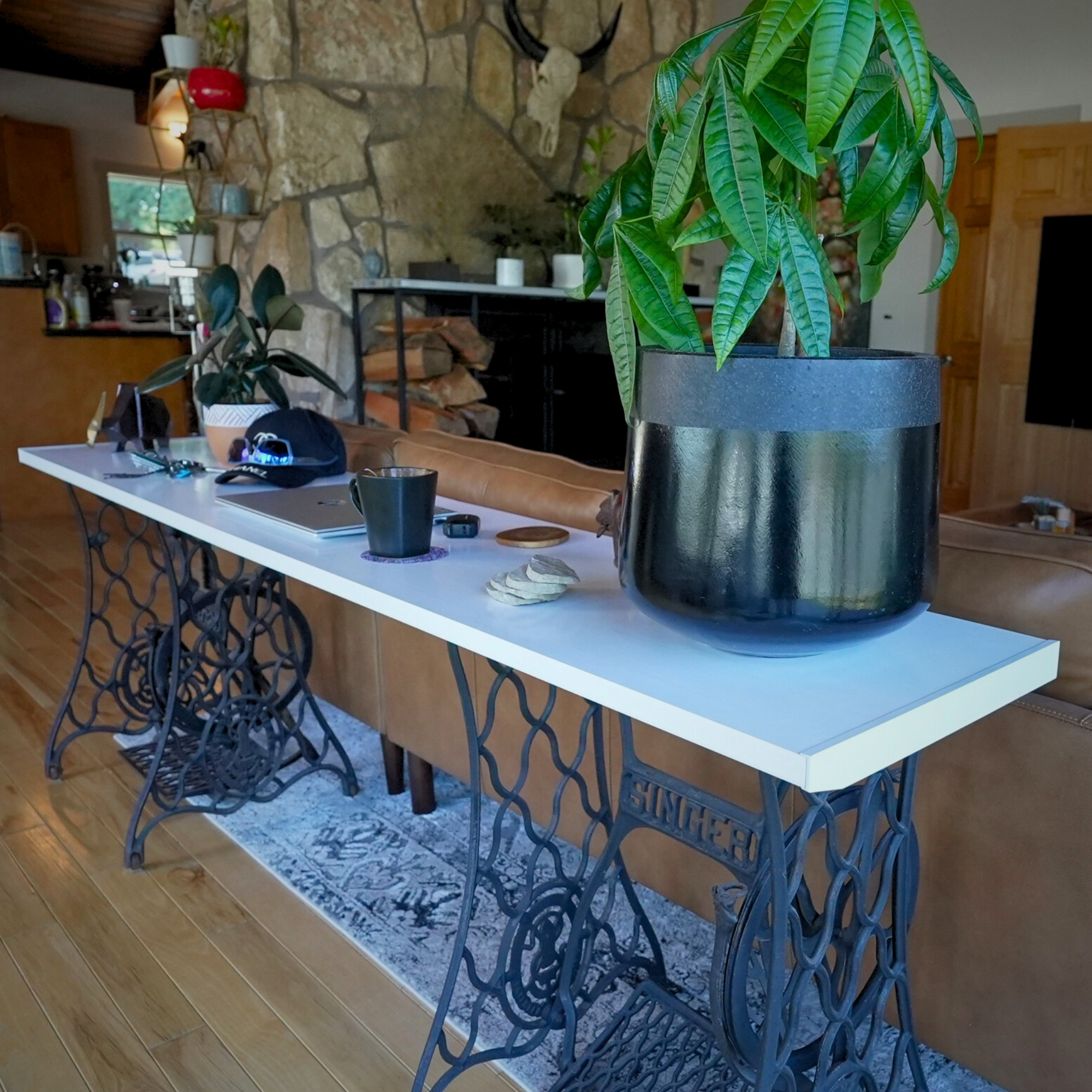 all-groups Repurposed sewing machine table with plants and decor in a home setting