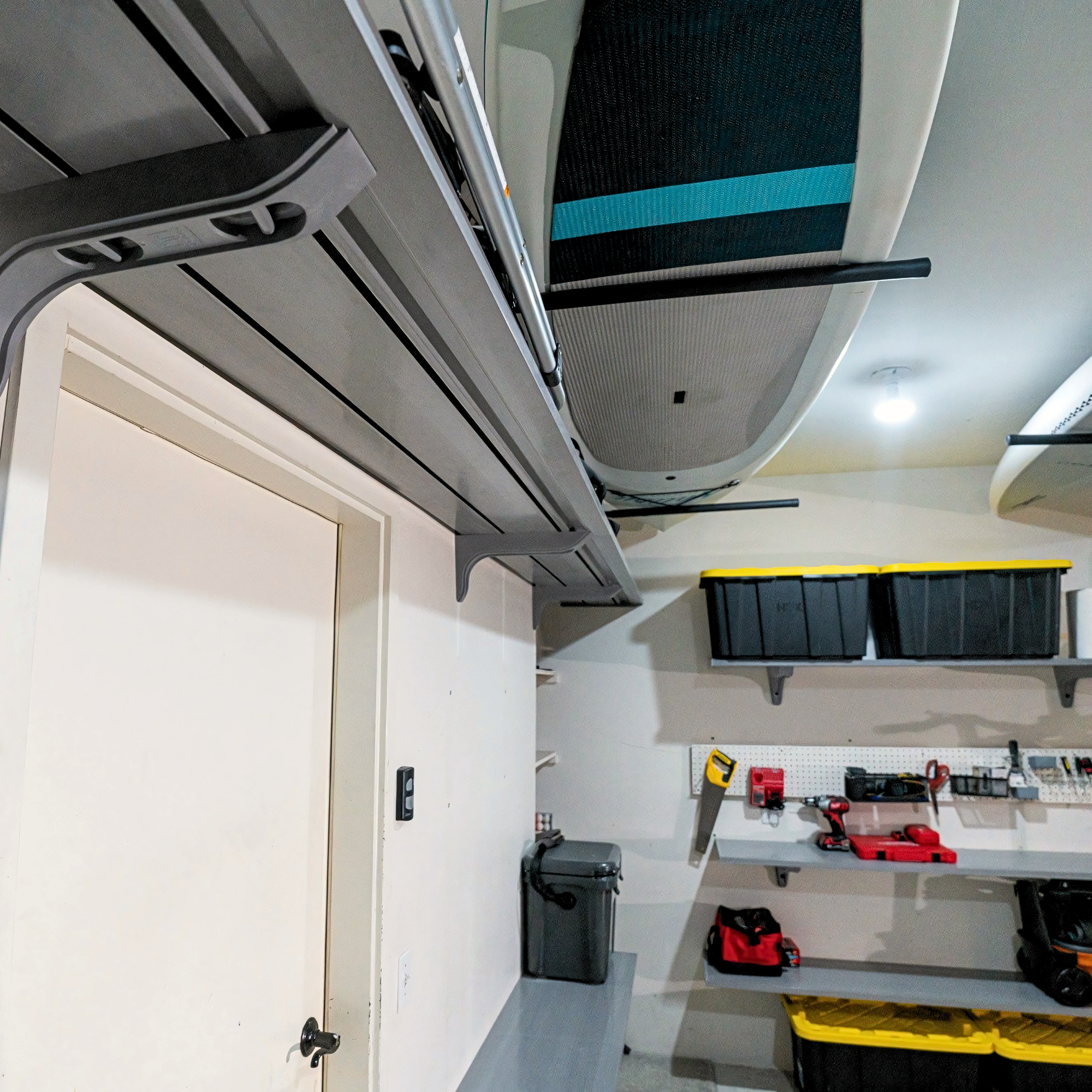 all-groups Wall-mounted Toden garage shelving run installed near ceiling with clean modular finish