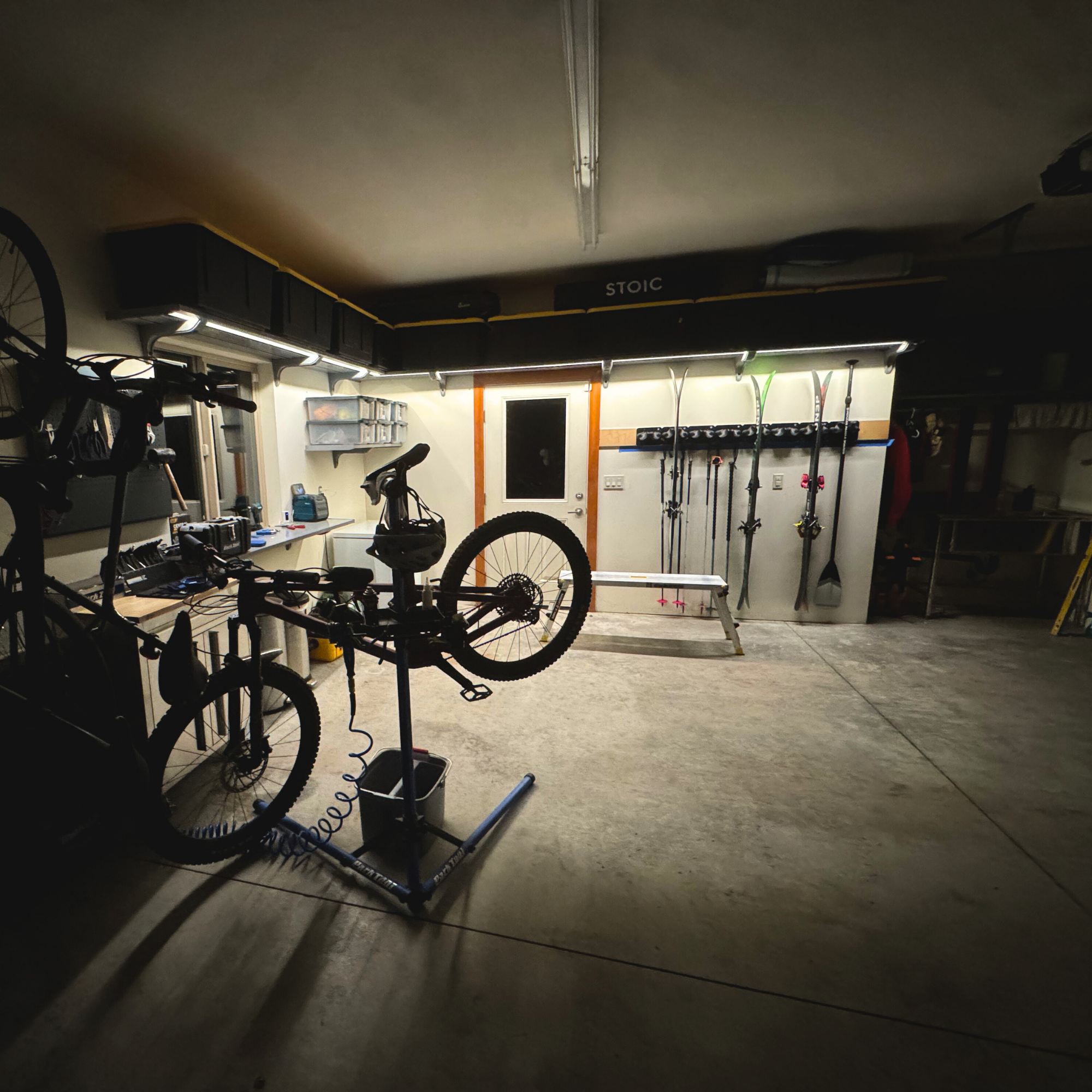 all-groups Bicycle on a stand in a workshop with Toden storage products with tools and equipment in the background