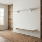 Toden white modular shelving system installed in a minimalist entryway. Two long, white floating shelves are mounted with industrial-strength brackets and integrated snap-fit hooks. This visual highlights the ultra-slim profile and the "no-diagonal support" design, creating a clean, unobstructed storage solution against a neutral wall.