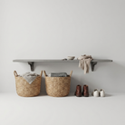 gray Toden gray modular surface configured as a minimalist floating entryway bench and organizer. The heavy-duty 72-inch gray shelf is mounted on a neutral wall, holding keys, a small bowl, and a linen scarf. Below the bench, large woven wicker baskets and rows of shoes are neatly organized, highlighting the space-saving "no diagonal support" design of the brackets in a modern mudroom setting.
