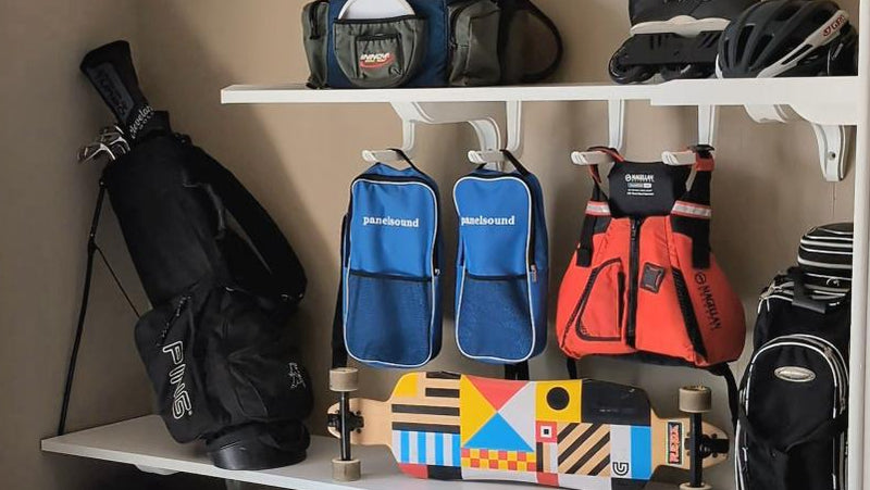 Closet with shelves holding various bags and sports equipment