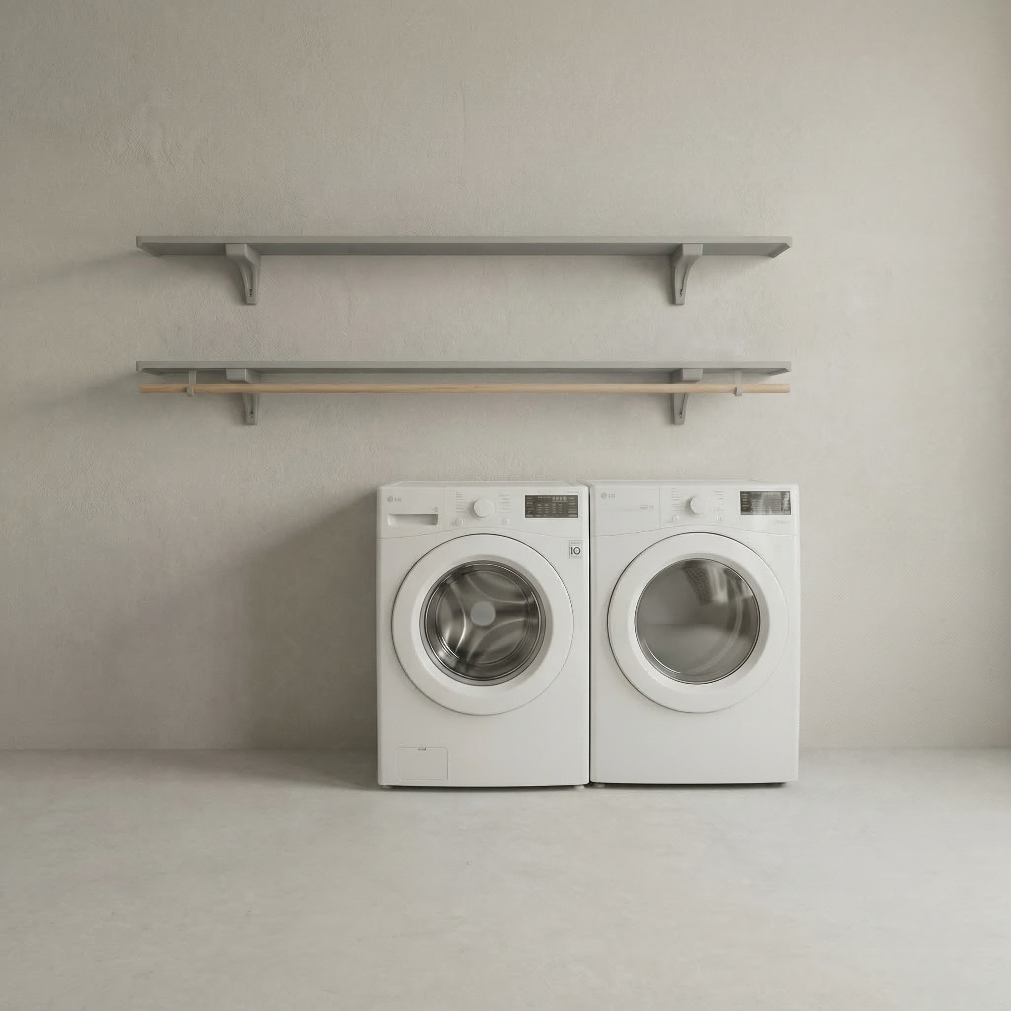 Toden gray modular laundry room storage system with a double-row shelf configuration. The setup features two 72-inch gray floating surfaces mounted above a white washer and dryer, with an integrated wooden closet rod for air-drying clothes. This visual highlights the sleek, no-diagonal support bracket design and the system's industrial-strength load capacity in a minimalist utility space.