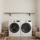 Toden gray modular surface installed as a minimalist laundry room shelf above a white washer and dryer. The setup features a single 72-inch gray floating surface supported by two industrial-strength brackets, highlighting the sleek "no diagonal support" design. This visual demonstrates a heavy-duty, open storage solution for maximizing utility space in a modern home.
