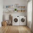 Toden white modular laundry room storage system on a white shiplap wall. The setup features a double-row of white floating shelves above a washer and dryer, with an integrated wooden closet rod for air-drying clothes. Styled with laundry supplies and wicker baskets, it highlights the heavy-duty, no-diagonal support design for a clean, organized laundry room.
