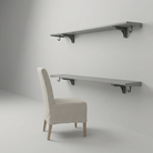 Toden gray modular double-row shelving system configured as a floating desk and upper storage shelf. The setup features two long-run gray panels mounted on a minimalist wall, supported by industrial-strength brackets with integrated snap-fit hooks. The design highlights maximum legroom and the system's "Modern Form" in a professional home office environment.
