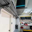 Wall-mounted Toden garage shelving run installed near ceiling with clean modular finish